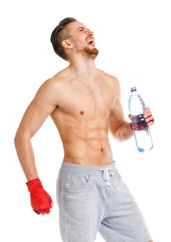 Athletic attractive man wearing boxing bandages with bottle of water on the white background