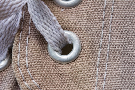 eyelet tab of canvas shoe, with shoelace, close-up