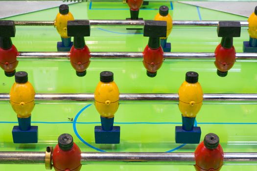 Table football game with yellow and red players