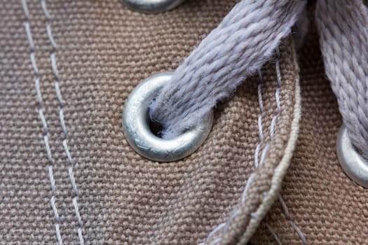 eyelet tab of canvas shoe, with shoelace, close-up