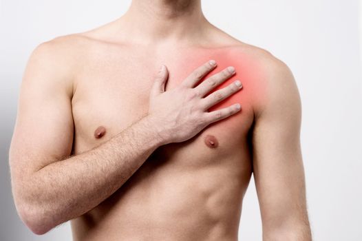 Male suffering pain on his chest muscle 
