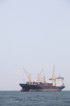 Large cargo ship Boats moored in the sea to make sense compared to the coast.