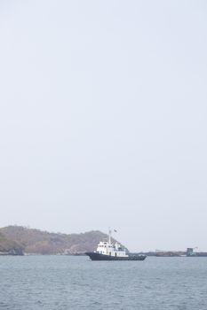 Large cargo ship Boats moored in the sea to make sense compared to the coast.