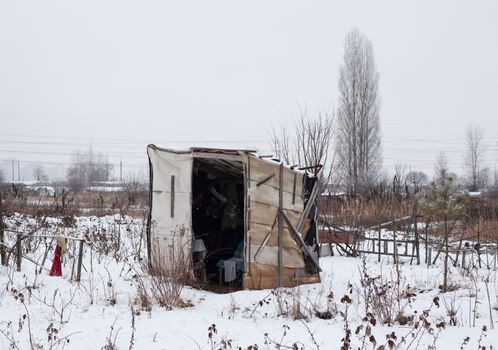 Temporary self-made shelter covered with the snow in winter.