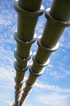 Elevated section of the pipelines against the cloudy sky