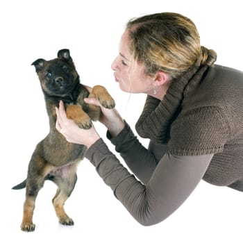 puppy malinois and woman in front of white background