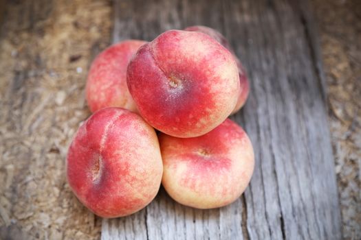 some fresh ripe  peaches on wooden background