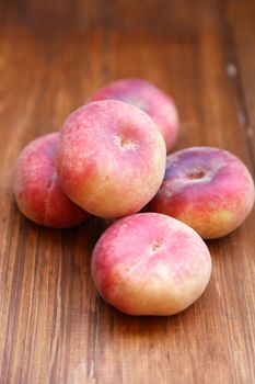 some fresh ripe  peaches on wooden background