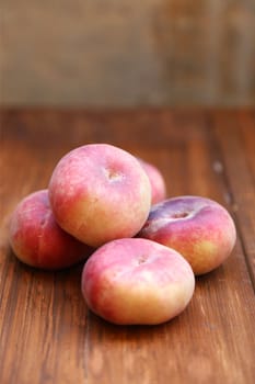 some fresh ripe  peaches on wooden background