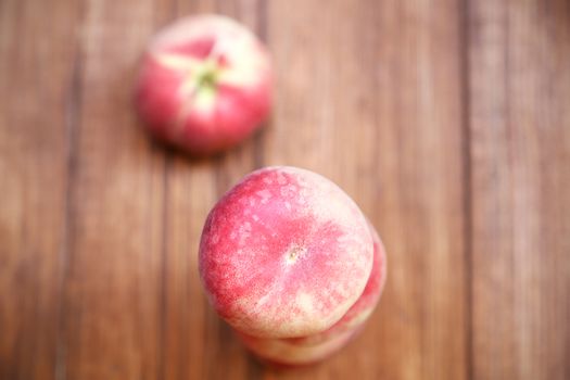 some fresh ripe  peaches on wooden background