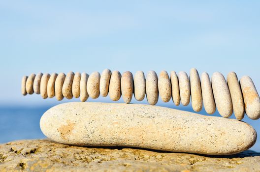 Stack of stones in connection each other on the seashore