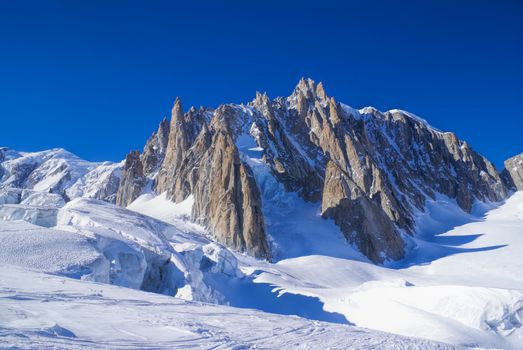 Breathtaking view of snowy mountains from the top in Valle Blanche