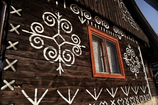 Painted facade of traditional wooden house in Slovakia in famous village of Cicmany