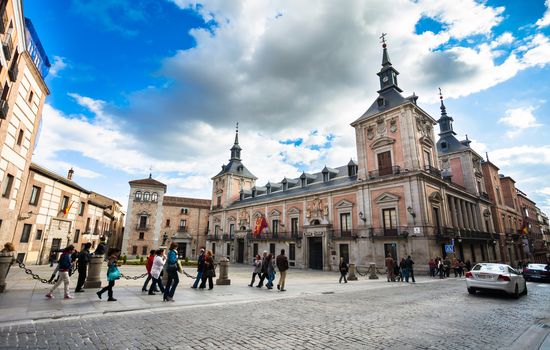 Madrid, Spain - May 6, 2012: Casa de la Villa in Villa Square (Plaza de la Villa) the City Hall of Madrid with tourist walking on a spring day, Spain