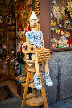 Madrid, Spain - May 6, 2012: Vintage wood toy shop with Pinocchio dool exposed on front in Madrid, Spain