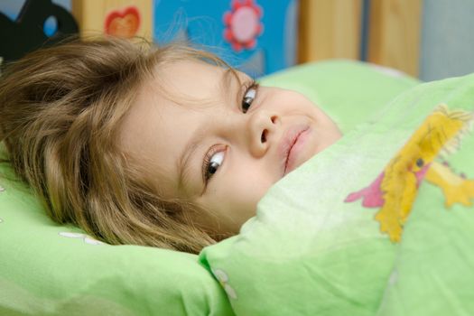 Six year old girl woke up in the morning in her crib