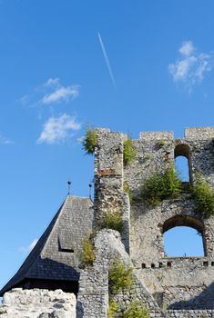 Contrail of the jet plane above ruin of Celje medieval castle in Slovenia