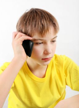 Sad Teenager with Cellphone on the White Background