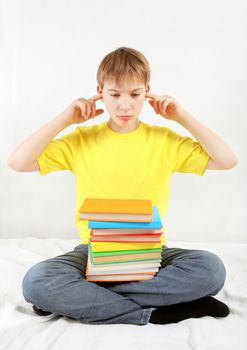 Stressed Kid with a Books cover the Ears on the Bed