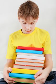 Sad Kid with a Books at the Home