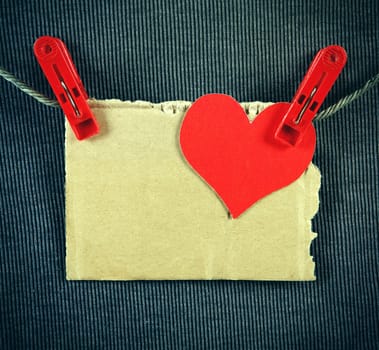 Red Heart Shape and Paper on the Rope and the Textile Background