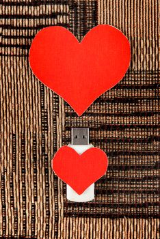 USB Flash Drive with Heart Shape on the Fabric Background