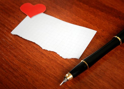 Blank Writing Pad with Heart Shapes and Pen on The Table