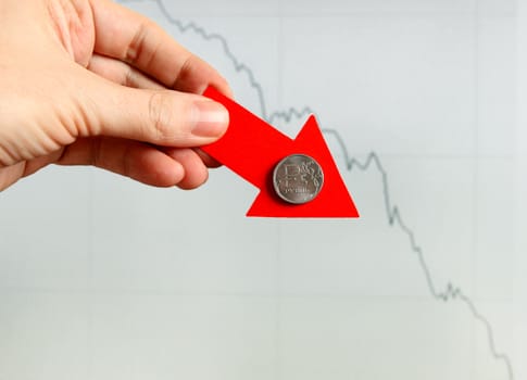 Red Arrow in a Hand with Russian Ruble Down on the Diagram Background