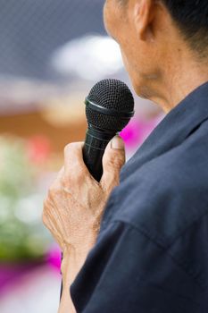 thai old man holding black microphone