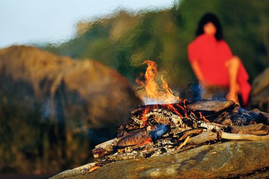 Woman in red dress on the seashore