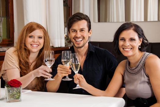 smiling happy people friends in restaurant for dinner 