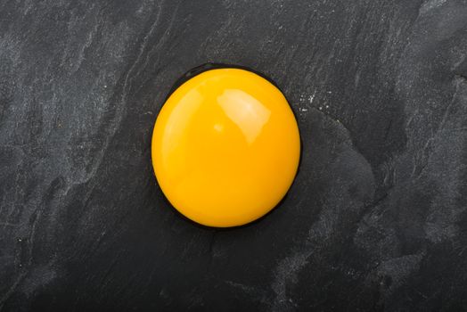 Raw egg close-up on black
