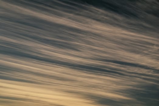 Close-up view of windswept sky slowly turning yellow