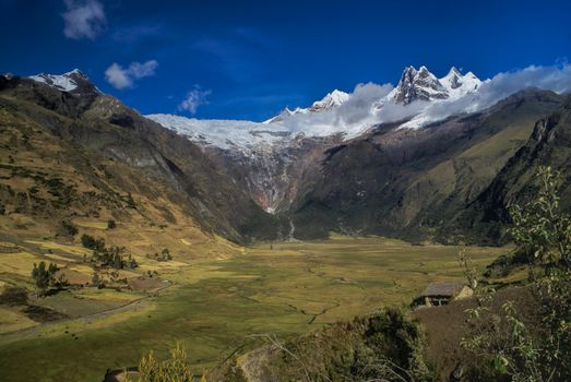 Picturesque green valley in between scenic mountain peaks of Peruvian Andes