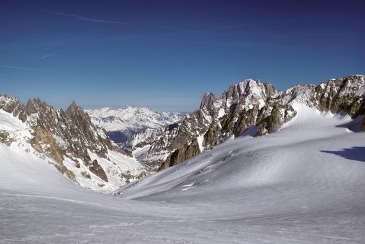 Breathtaking view of snowy mountains from the top in Valle Blanche