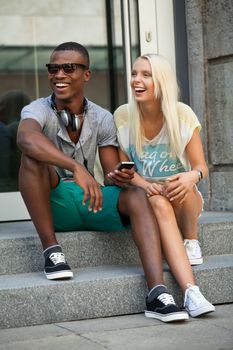 happy young couple have fun in the city summertime outdoor smiling lifestyle