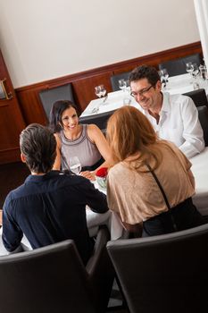 Waiter happily accommodating couple with a big smile on his face