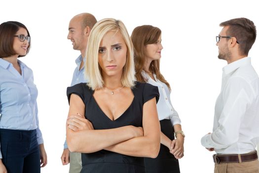 Successful business team of diverse young executives standing cheering and celebrating their success with an attractive young businesswoman or team leader in the foreground, on white