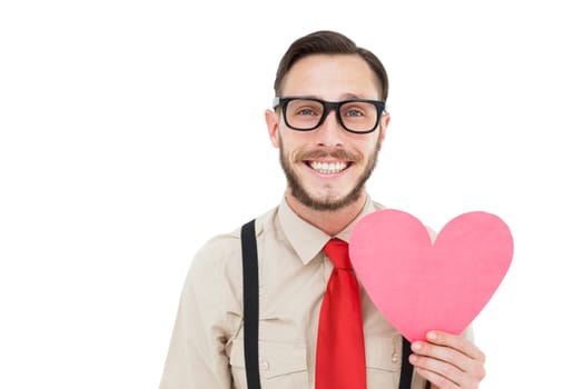 Geeky hipster smiling and holding heart card on white background