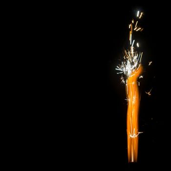 Burning Firework Sparkler Detail  isolated on black with huge copy-space, square