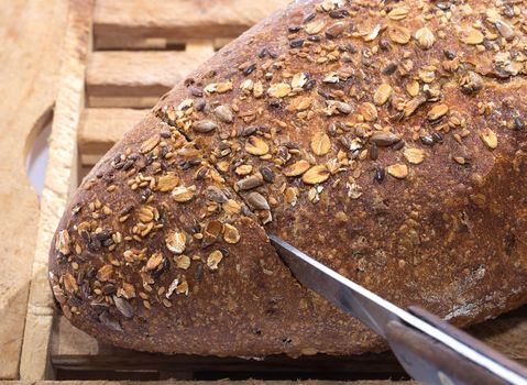 Knife Cutting Whole Grain Bread Detail