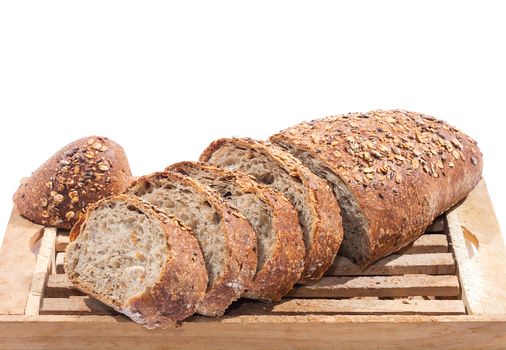 Sliced Whole Grain Bread on Wooden Cutting Board over white background