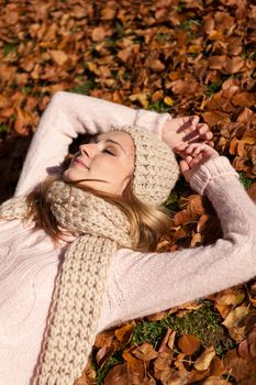 young smiling woman with hat and scarf outdoor in autumn nature background