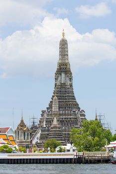 The Temple of Dawn, Wat Arun, on the Chao Phraya river and a beautiful blue sky in Bangkok, Thailand