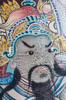 Painting face of ancient Asian warrior on a door in Wat Pho is the important temple in Bangkok, Thailand.