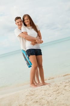 happy young couple on the beach in summer holiday love togetherness