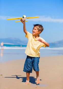 Beach kid boy kite flying outdoor coast ocean