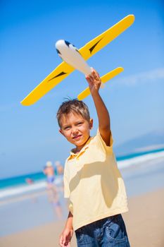 Beach kid boy kite flying outdoor coast ocean