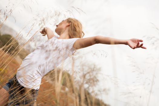 young happy attractive woman arms wide open nature outdoor breathing 