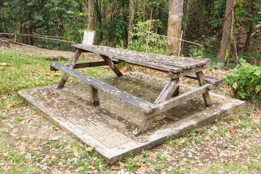 Abandoned wooden bench in thai public park.